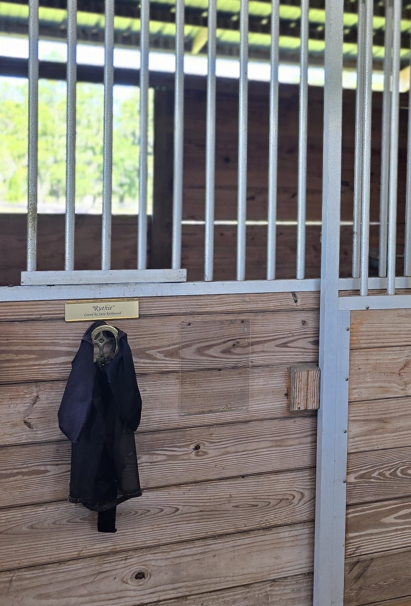 Ruthie&rsquo;s empty stall, her nameplate reading &lsquo;Loved by Sara Kirkwood&rsquo;
